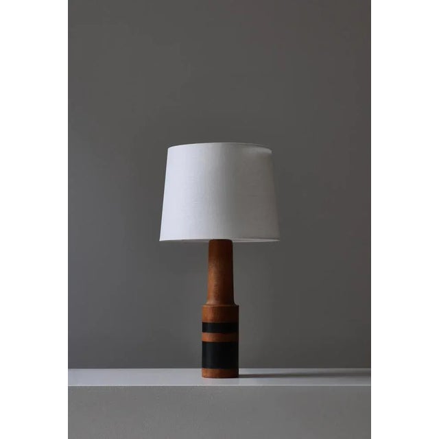 Unique Danish Modern table lamp handmade in Denmark in the 1950s. Turned oakwood with a beautiful patina and black...