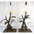 A pair of painted and green metal banana leaf lamps with woven rope shades and pineapple-shaped finials. The shade and...