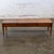 Marvelous vintage Neoclassic coffee table composed of a long, fairly low walnut toned hardwood frame with 3 section carved...