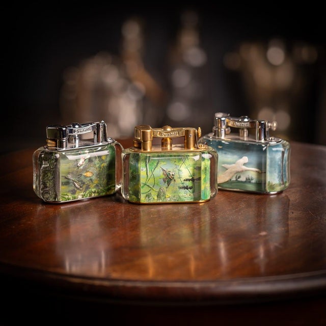Vintage mid 20th Century Dunhill Aquarium table lighter. Crafted in a curved rectangular shape with gold plated mounts,...