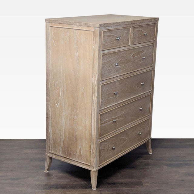This Arhaus dresser features a light wood finish and a clean, modern look. It has six spacious drawers with metal knobs,...