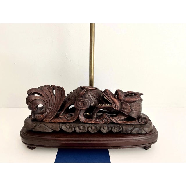 Stunning Asian hand-carved wood dragon lamp with intricately detailed scales, scrolls, and teeth. Most likely a former...