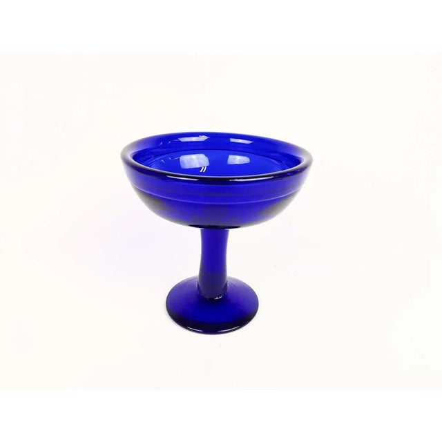 This blue bowl was made at Boda and designed by Erik Höglund in Sweden, 1960s. The bowls blue color gives the glass that...