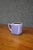 Early American art pottery mug attributed to Van Briggle, featuring a softly rounded cylindrical form with simple loop...