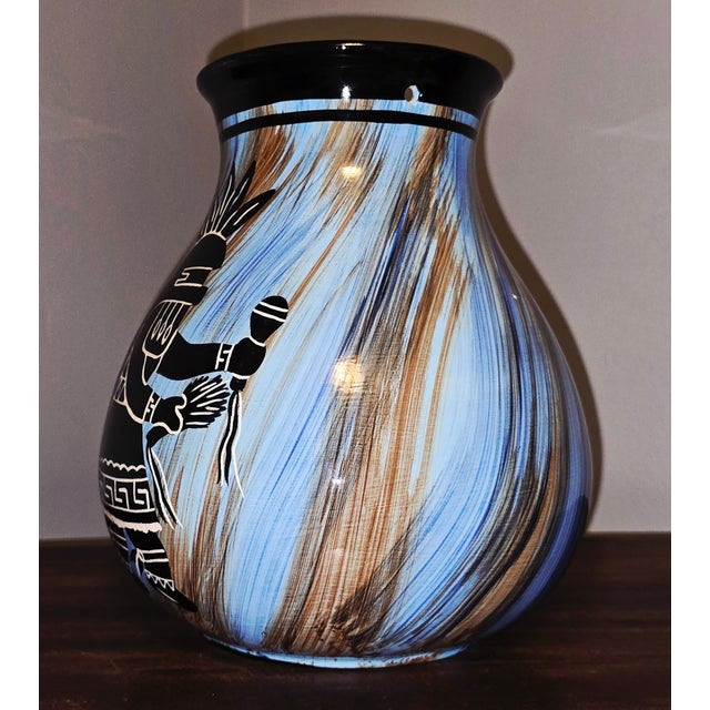 A striking fusion of Southwestern artistry and 1970s studio craftsmanship, this hand‑painted ceramic vase by Mapaw...