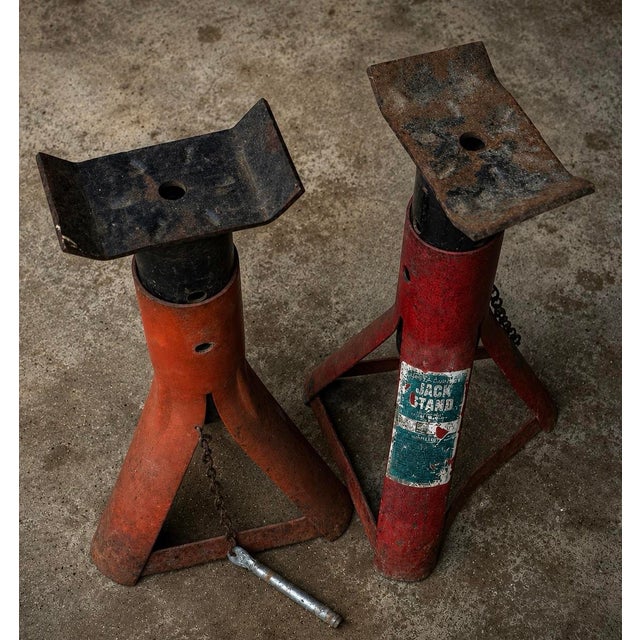 Pair of vintage steel jack stands with heavy industrial presence and aged surface character. Suitable for architectural...