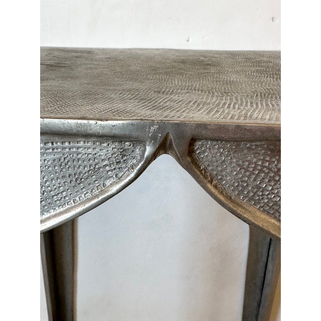 Moroccan style chic cast aluminum end table having textured top.