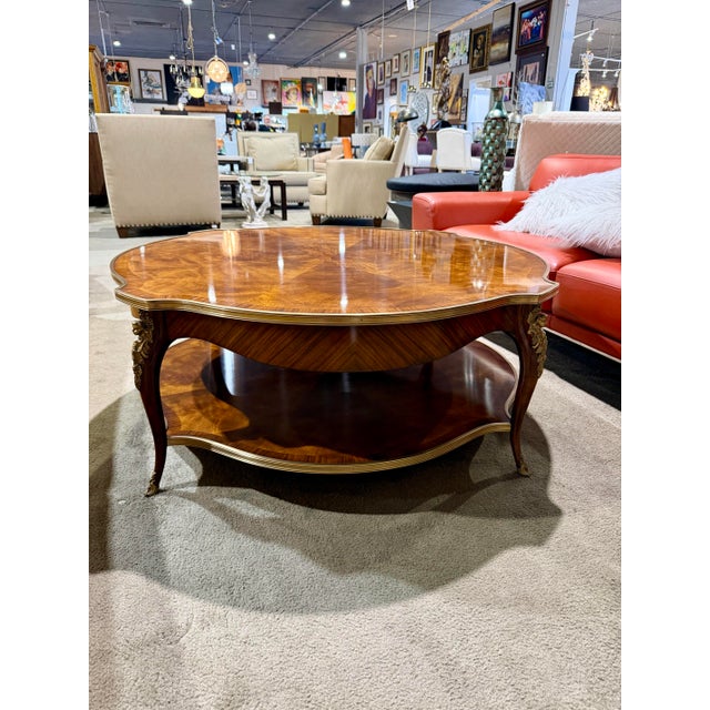 A refined and timeless cocktail table from the Althorp collection by Theodore Alexander, crafted in rich mahogany with a...
