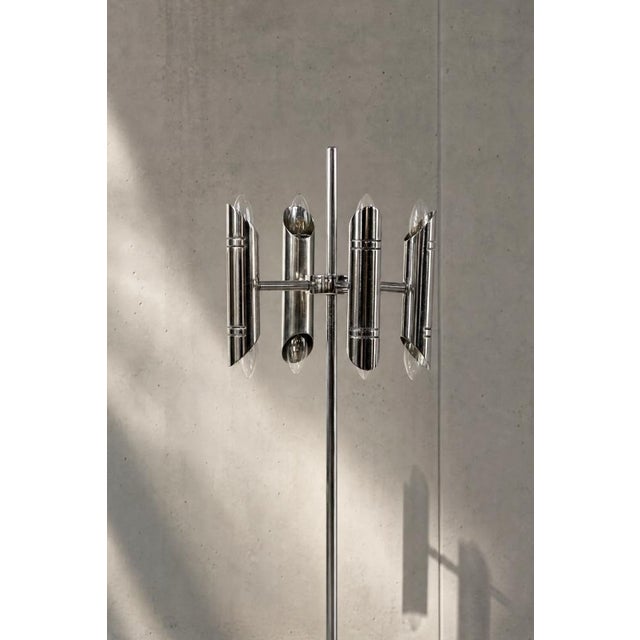 This vintage floor lamp was produced in Italy during the 1960s. It is made of chrome-plated elements mounted on a red...