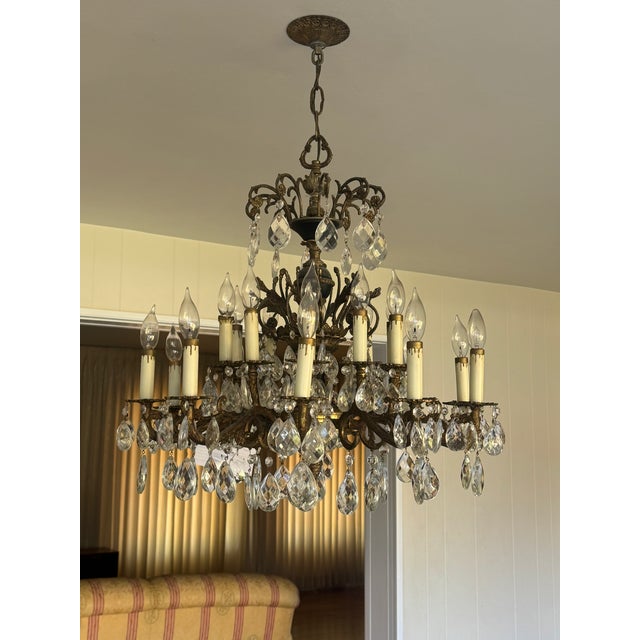Vintage Brass & Crystal Chandelier with 2-levels of candles. The brass body of fixture has tree branch style detail,...