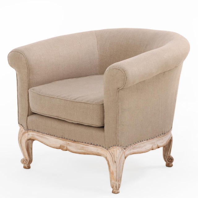 This pair features distinctively curved and rolled arm frames with upholstered backs and arms, supported by carved and...