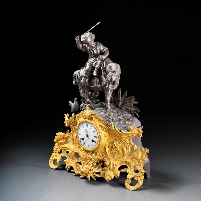 An impressive French mantel clock dating to the mid-19th century, featuring an elegant combination of richly gilt bronze...