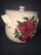 Home & Garden Party apple-patterned stoneware bean pot featuring a cream-colored glazed body with a cluster of red apples...