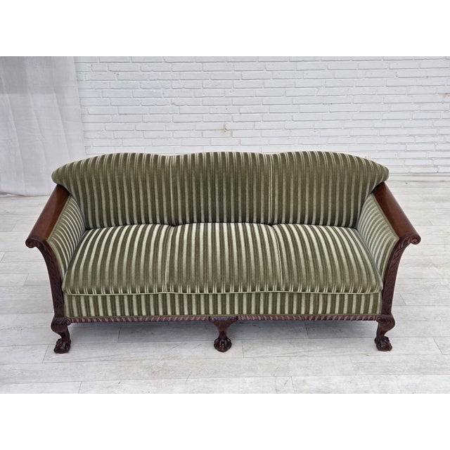 1950s, 3-seater Danish sofa. Striped green furniture velour, laqered teak wood, brass springs in the seat. Sofa was...