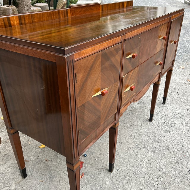 A striking American Art Deco waterfall buffet sideboard dating from the late 1930s to early 1940s. This exceptional piece...