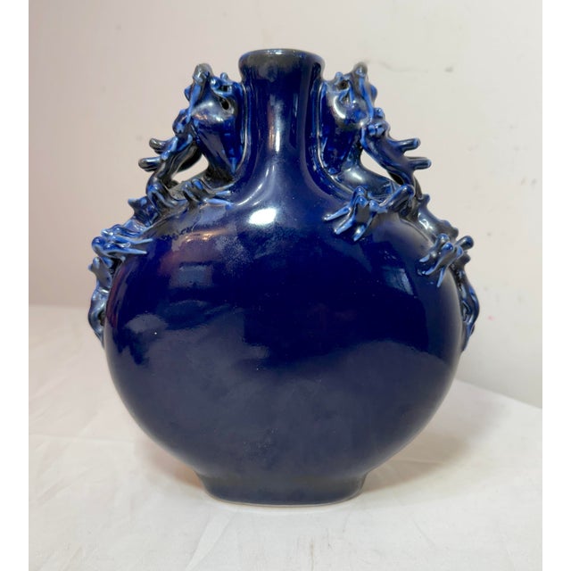 This vintage handmade Chinese cobalt blue dragon vase is a stunning piece of Asian decor. Made from a cobalt blue high...