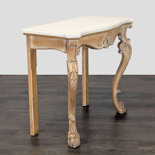 Stone top on carved base with cabriole legs and paw feet. Dimensions (in): 42W x 21D x 37H.