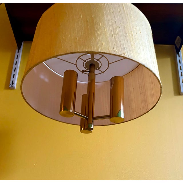 Th. Valentiner. Ceiling lamps with brass frames with three light sources, fabric shade, white plastic shade. 1970s. ....