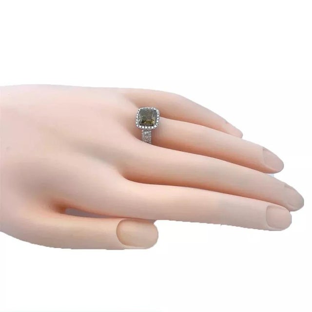 This is a stunning engagement ring, it is crafted from 14k white gold with small white princess cut diamonds along the...