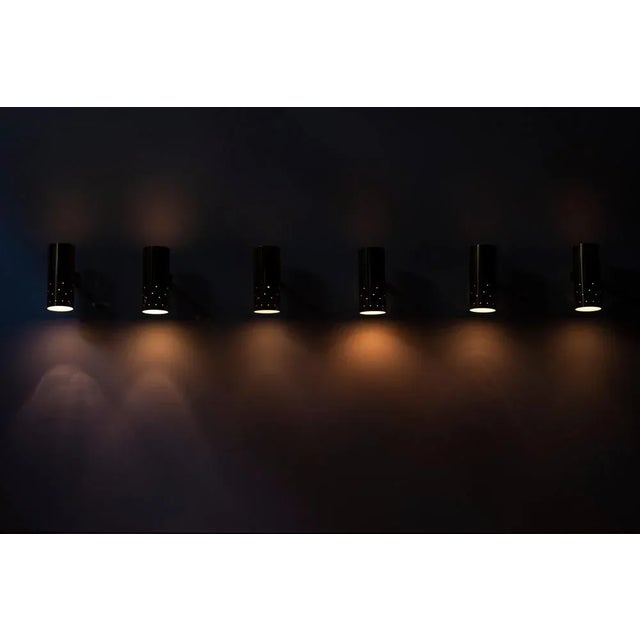 Brass wall lamps designed and produced in Sweden during the 1950s. Perforated lamp shades. Made with hard wire for...