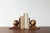 A pair of wooden bookends with a distinctive, geometric form. Each bookend consists of a heavy, rectangular base and a...