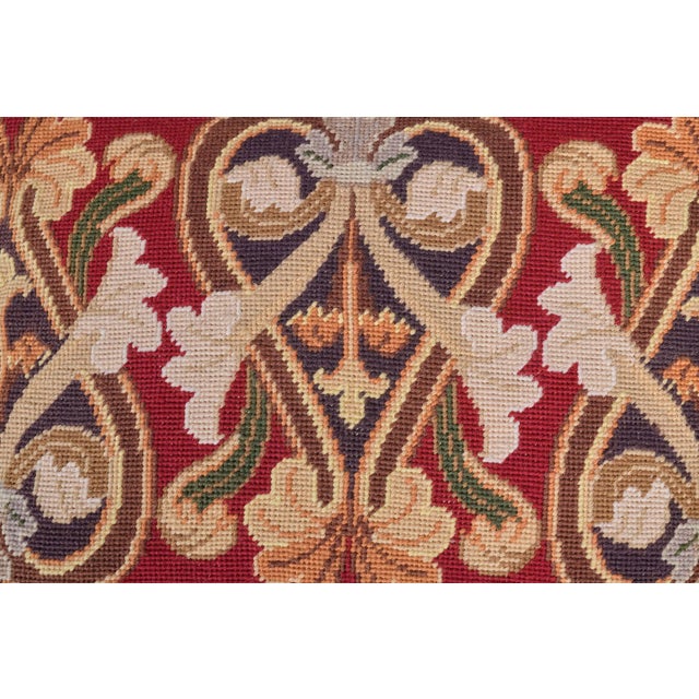 Vintage wool needlepoint cushion decorated with hearts and floral patterns with a green velvet back.