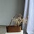 Small oval basket with long handles, traditional Indonesian style. Handwoven rattan from Lombok. Elongated oval shape with...