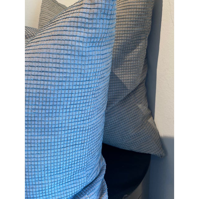 This pair of sophisticated accent pillows features a light blue and grey micro-textured weave, creating a subtle grid...