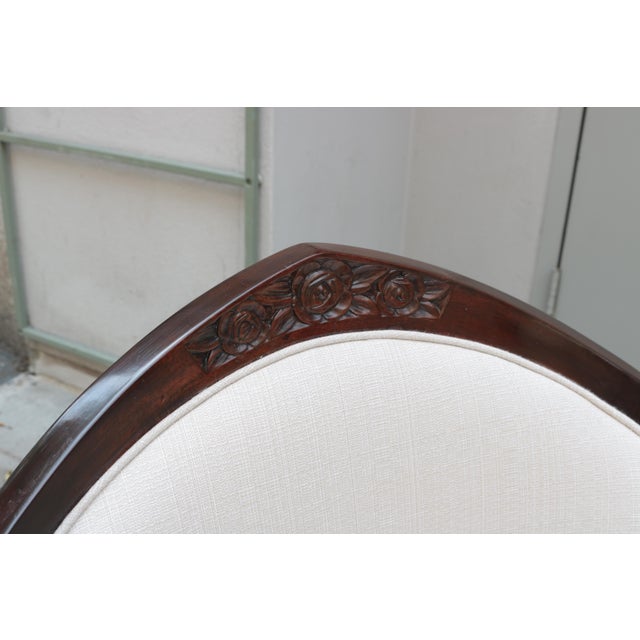 A pair of Art Deco bergères. Stanied wood frames with carved details on the central backrest of the frame.
