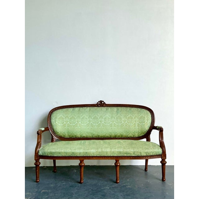 This elegant vintage French Provincial canape exudes timeless European charm and sophisticated craftsmanship. Featuring a...