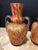 A pair beautiful hand blown Italian multi colored art twin handled glass vases. an array of abstract murrina make up these...