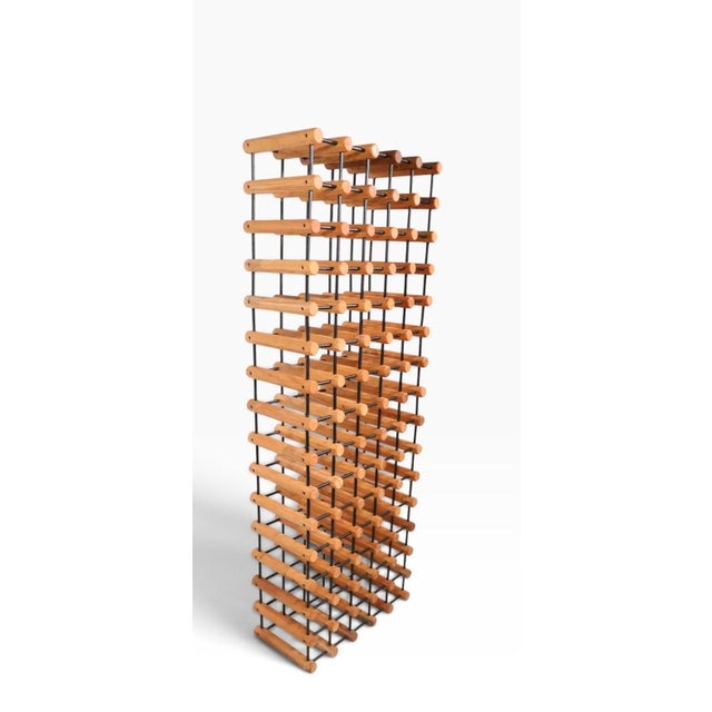 Impressive freestanding, floor model wine rack, constructed of repeating octagonal wood elements within the black metal...