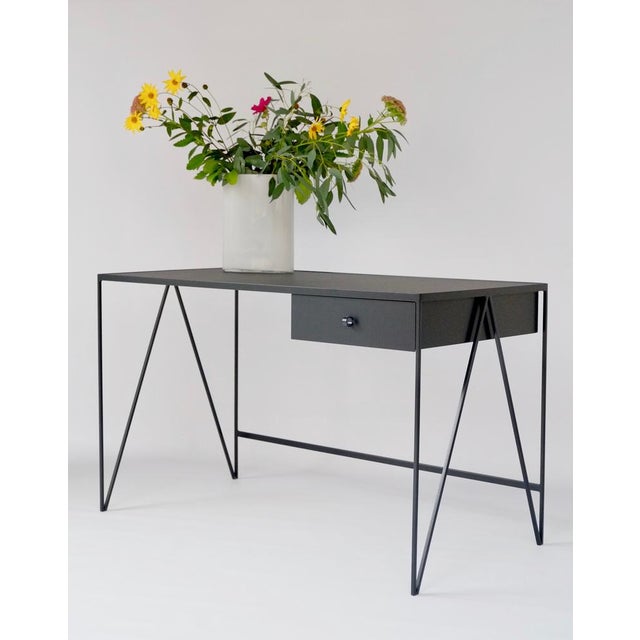 This Study desk is made with a black powder-coated steel frame and a black linoleum top made from all-natural ingredients,...