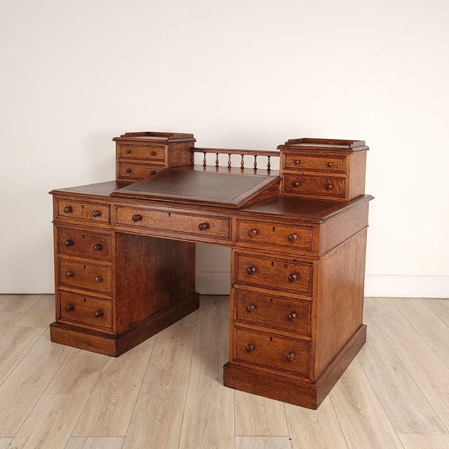 A Victorian English oak desk. The outside height (i.e., from the floor to the main desk surface) measures 29.25"; height...