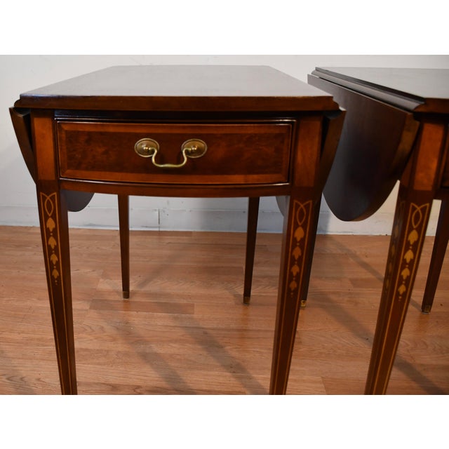 We are pleased to offer this beautiful pair of English Sheraton Pembroke drop-leaf side tables, by Hickory Furniture from...