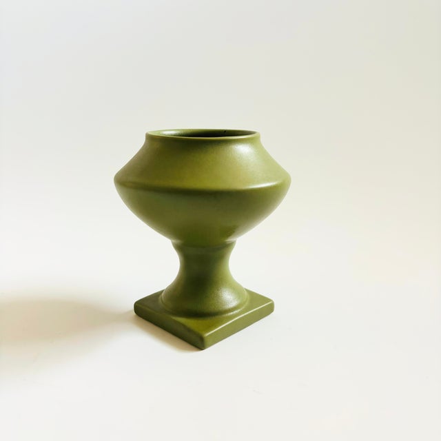 A vintage ceramic vessel for using as a small planter or vase. Lovely matte green glaze.