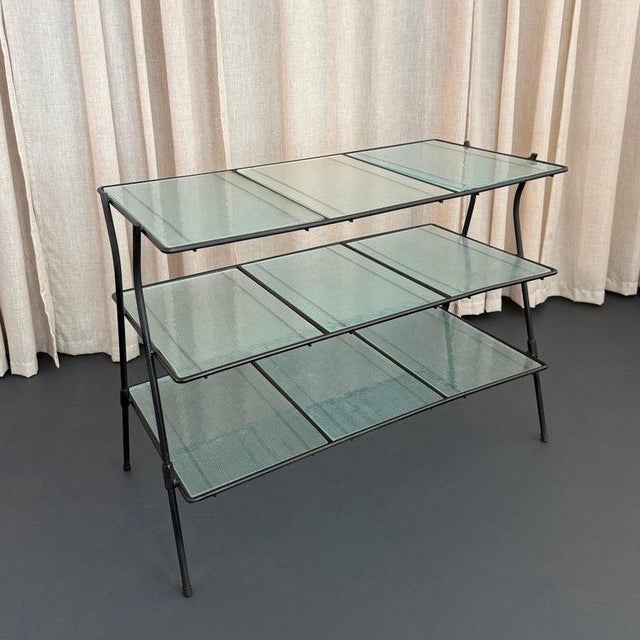 This Mid-Century Modern tiered indoor/outdoor side table console is in the style of mid-century makers Salterini and...