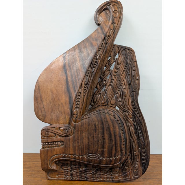 Bring striking tribal artistry and architectural dimension to your walls with this powerful decorative hand-carved wood...