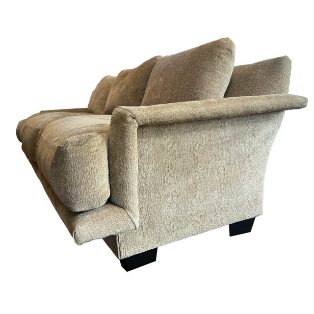 A mid-century style sofa with a sleek angular silhouette upholstered with plush camel-colored velvet. One-of-a-kind with...
