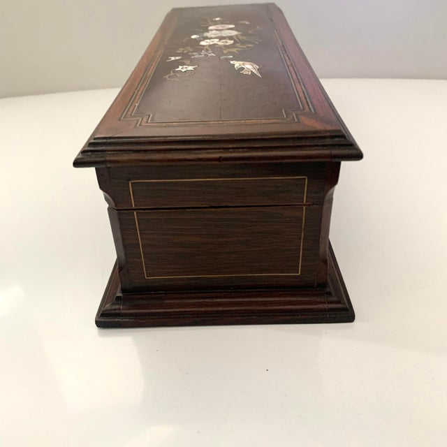 The mother of pearl bird and flower inlay make this rectangular box exquisite. Red tufted satin lining. Size: 13.5" w, 5"...