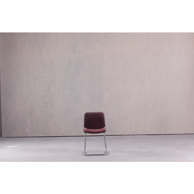 This vintage Italian dining chair dates from the 1970's and features a chromed tubular steel frame with dark brown fabric...
