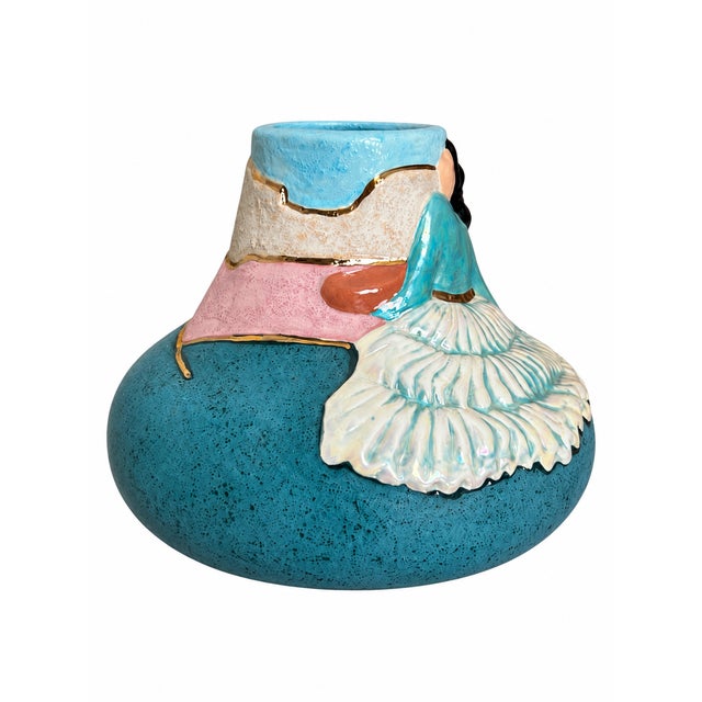 A sculptural Southwestern-style ceramic vase featuring a broad rounded body, tapered neck, and richly speckled turquoise...