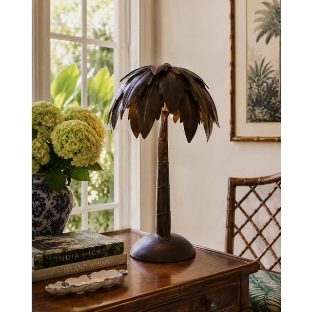 A chic vintage metal palm tree table lamp in the manner of Maison Jansen, with a sculptural trunk, layered palm frond...