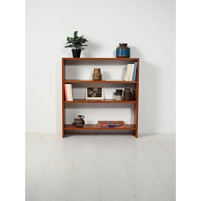 Scandinavian teak bookcase with three adjustable shelves and minimalist lines, Nordic production from the 1960s....