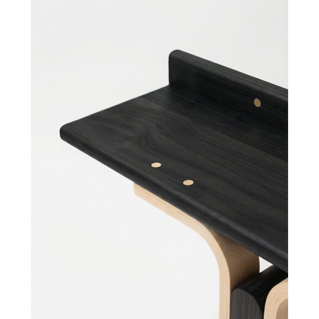 The Rennie Console Table by Ilaria Bianchi is a refined 21st-century piece, handcrafted from black-stained walnut and ash...
