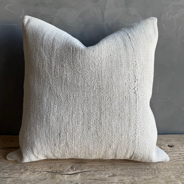 Creamy white hemp rug pillow with original seams. Soft hand, linen blend backing with zipper closure. Spot cleaning is...