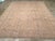 A soft brown tone uncluttered ground supports five columns of iconic Oushak-style Harshang palmettes and elaborate lozenge...