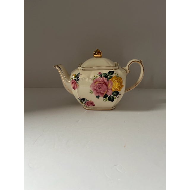 This elegant mid-century English teapot by Sadler was crafted in Staffordshire, England, and features a refined floral...