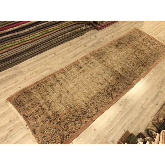 This is a vintage Turkish Oushak rug from the 1960s. The piece was hand-knotted.