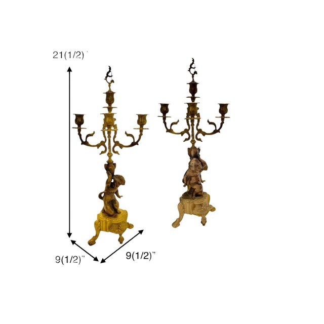 This pair brass candelabra features a charming cherub design, perfect for adding a touch of angelic detail to your home...